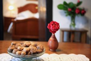 a bowl of nuts sitting on a table with a vase at Casa Rural Mokorrea in Etxalar +19 photos