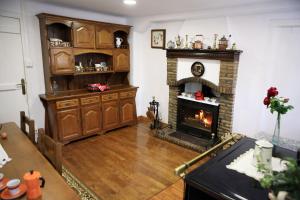 a living room with a fire place in a fireplace at Casa Rural Mokorrea in Etxalar