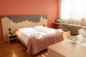 Postel nebo postele na pokoji v ubytování SwissEver Hotel Zug