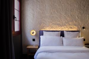 a bedroom with a large bed with white pillows at Letoh Letoh Bilbao in Bilbao