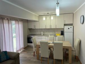 a kitchen and dining room with a table and chairs at Villa 4 Princesses in Vela Luka