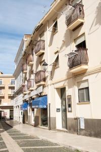 a building with balconies on the side of a street at Queen Elena in Civitavecchia