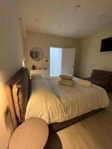 a bedroom with a large bed and a couch at Tecla Apartment in Reggio di Calabria