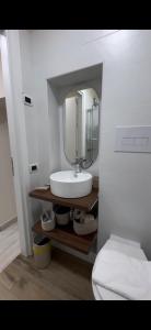 a bathroom with a sink and a mirror at Tecla Apartment in Reggio di Calabria +12 photos
