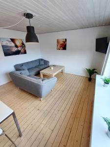 a living room with a couch and a table at Bright and central city apartment near Aalborg Business School in Aalborg