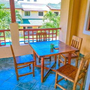 a wooden table and chairs on a balcony at Modern Girasoli Suites 03 in Malindi
