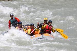 a group of people in a raft in the water at Archontiko Tzoumerkon in Ágnanta