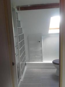 a bathroom with a toilet and a window at Les Noisettes Sauvages proche Etretat in Villainville +31 photos