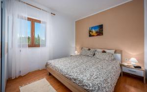 a bedroom with a bed and a window at Klaudio Aqua Oaza Drenje in Drenje +84 photos