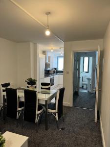 a kitchen and dining room with a table and chairs at Stylish 4 Bd Ft LDN Parking in London +21 photos