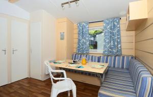 a small dining room with a table and chairs at Domaine Résidentiel de Plein Air Odalys La Pinède in Agde