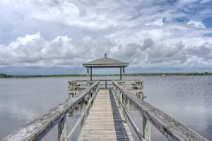 a wooden dock with a gazebo on the water at Amazing Sound View Home with Pool in North Topsail Beach