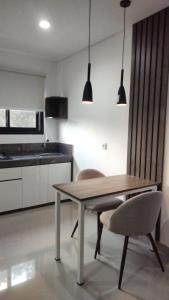 a kitchen with a wooden table and two chairs at Apartement Lucky Jimbaran in Jimbaran