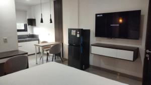 a kitchen with a black refrigerator and a table with chairs at Apartement Lucky Jimbaran in Jimbaran