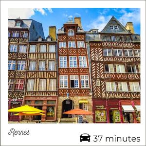 a group of tall buildings with umbrellas in front of them at L'Eden - calme et luminosité au coeur de la ville in Fougères