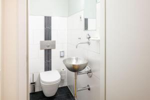 a bathroom with a sink and a toilet at Hapimag Berlin Gendarmenmarkt in Berlin +39 photos