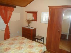 a bedroom with a bed and a dresser and a mirror at Danko Apartments in Brna