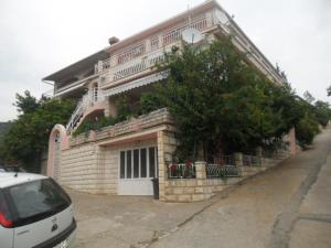 a white car parked in front of a building at Danko Apartments in Brna