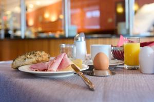 a table with a plate of food and eggs on it at Das Hotel Eden - Das Aktiv- & Wohlfühlhotel in Tirol auf 1200m Höhe in Seefeld in Tirol