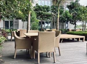 a table and chairs in a courtyard with trees at Serenity Staycation Studio in Iloilo City