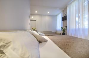 A bed or beds in a room at Albergo Silvio