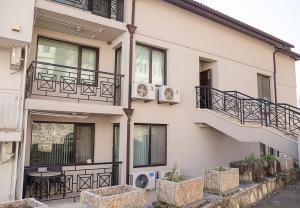 a building with balconies and stairs on the side of it at Cozy Seaside Escape - Stylish 1-Bedroom Apartment in Central Balchik by Flat Mаnager in Balchik