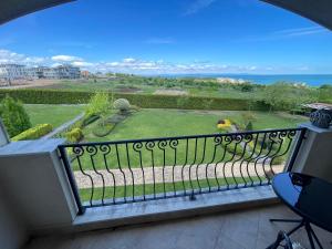 a balcony with a view of a garden at Sunset in Chernomorets