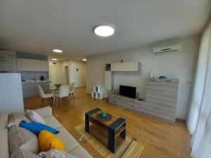 a living room with a couch and a table at Sunset in Chernomorets