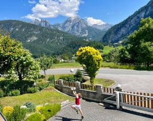 a woman playing with a frisbee in the mountains at Ferien am Sonnberg in Unken