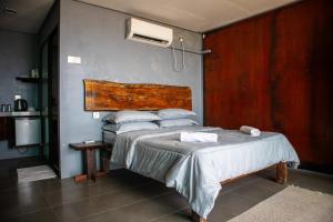 a bedroom with a bed with a wooden headboard at Pondok Beach Shack in Tioman Island