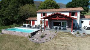a house with a swimming pool in front of it at Kurutxiaitako borda in Lasse