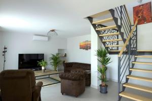 a living room with a spiral staircase and a couch at Kurutxiaitako borda in Lasse