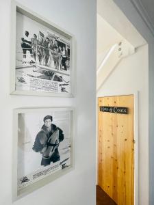 a hallway with two pictures on the wall and a door at Baywatch Mawgan Porth Spacious Home sleeps 9, Games room, Parking & Garden in Mawgan Porth +36 photos