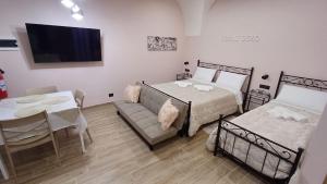 a bedroom with a bed and a table and a couch at Sogni D'oro 01 in Partinico