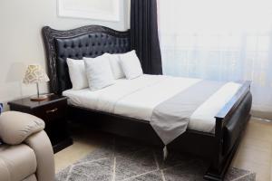 a bedroom with a large bed and a window at Affordable Luxury Ruaka in Ruaka