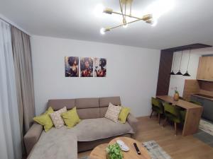 a living room with a couch and a table at Stan na dan Paradiso in Lukavica