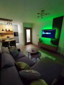 a living room with a couch and a green light at Stan na dan Paradiso in Lukavica +22 photos