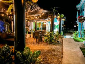 a patio at night with a table and lights at Pondok Beach Shack in Tioman Island