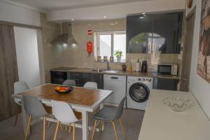 a kitchen with a table and chairs and a sink at Alvor Lemon House in Alvor