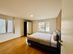 a bedroom with a bed and a window at TONIGHT Apartments in Bottmingen