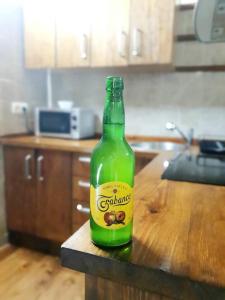 a green bottle of beer sitting on a table at Casina del Alba By Silastur in Campiellos