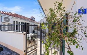 a house with a gate and a fence at 2 Bedroom Gorgeous Apartment In Vezac in Vezac