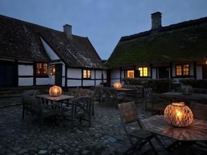 a courtyard with tables and chairs with pumpkins on them at Lodsoldermandsgården in Rørvig