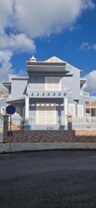 a white house with a fence in front of it at Dona Ana Guesthouse in Lagos