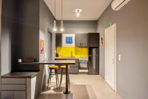 a kitchen with a counter and stools in it at Nemas Vista Loft A in Agia Marina