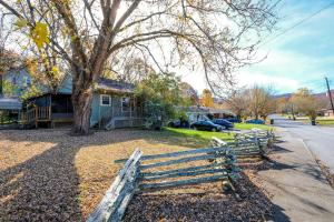a wooden fence in front of a house at Steps away from PF parkway, pet friendly, hot tub! in Pigeon Forge