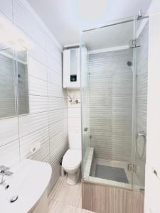 a bathroom with a shower and a toilet and a sink at Seven Apart Hotel in Vyshneve +118 photos