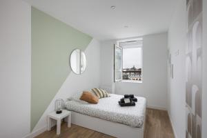 een witte kamer met een bed en een raam bij T3 Le Foudroyant in Brest