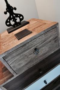 a wooden dresser with a wooden drawer with a metaligilidding at Pyne Arms in Barnstaple