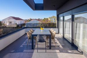 a table and chairs on the balcony of a house at Black Diamond in Novalja